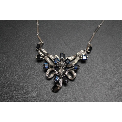 177 - AN 18K WHITE GOLD SAPPHIRE AND DIAMOND NECKLACE, having fourteen emerald cut sapphires interspersed ... 