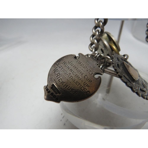 184 - A SILVER POCKET WATCH CHAIN, hallmarked to each link, with two fob medals and a small base metal pad... 