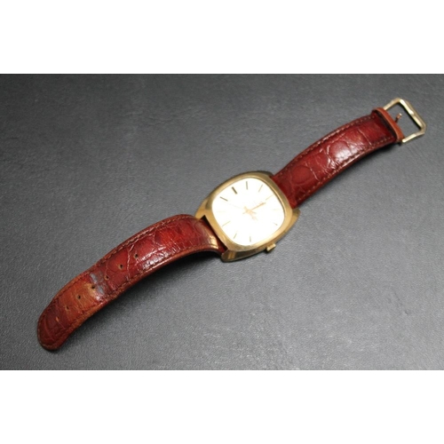 188 - A HALLMARKED 9 CARAT GOLD MARVIN REVUE DAY DATE QUARTZ WRIST WATCH, on leather strap with plated fas... 