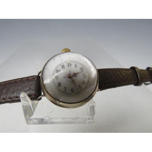 198 - AN UNUSUAL TRENCH WRISTLET WATCH, with domed glass and visible workings, Dia. 2.5 cm