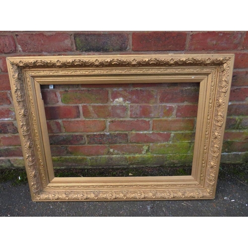 20 - A GILT RECTANGULAR PICTURE FRAME, foliate moulded detail throughout, rebate 75 x 50 cm