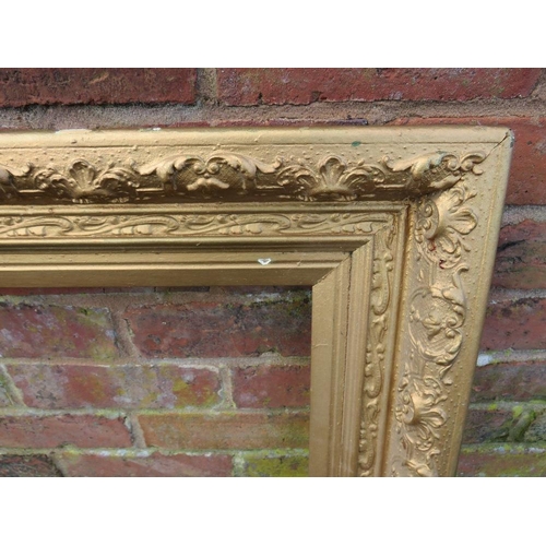 20 - A GILT RECTANGULAR PICTURE FRAME, foliate moulded detail throughout, rebate 75 x 50 cm