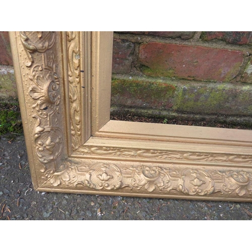 20 - A GILT RECTANGULAR PICTURE FRAME, foliate moulded detail throughout, rebate 75 x 50 cm