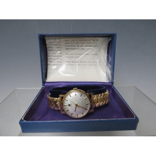 203 - A TISSOT 9CT GOLD CASED WRISTWATCH, on expanding yellow metal strap, together with original box and ... 