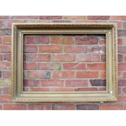 21 - A GILT RECTANGULAR PICTURE FRAME, with egg and dart moulded detail, rebate 82 x 57 cm