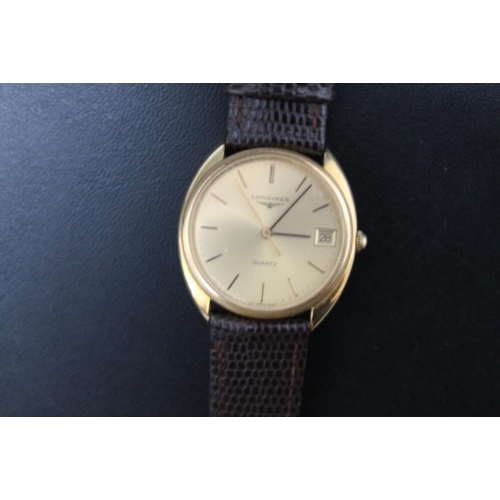 214 - LONGINES - A 1980'S GOLD PLATED QUARTZ DATE WRIST WATCH, on replacement leather strap, Dia 3.5 cmCon... 