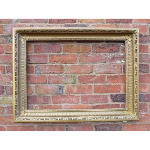 23 - A GILT RECTANGULAR PICTURE FRAME, with egg and dart moulded detail, rebate 82 x 57 cm