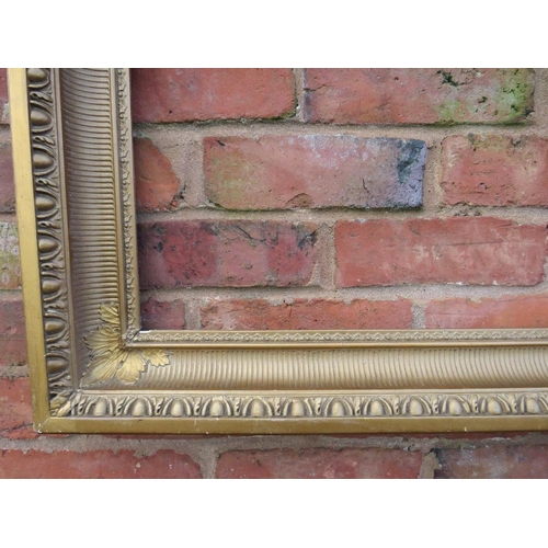 23 - A GILT RECTANGULAR PICTURE FRAME, with egg and dart moulded detail, rebate 82 x 57 cm