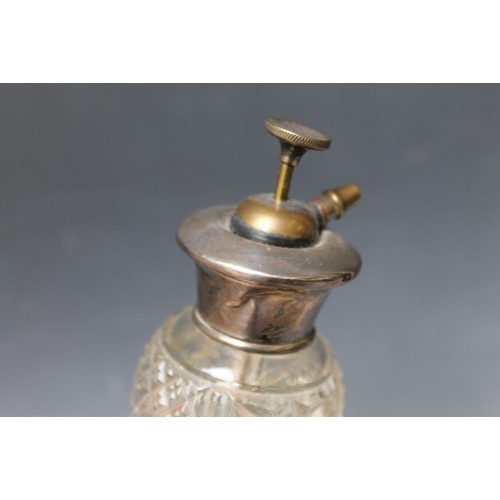 233 - A SILVER AND GUILLOCHE ENAMEL TOPPED CUT GLASS ATOMIZER, in rich ruby red enamel, stamped 'Sterling'... 