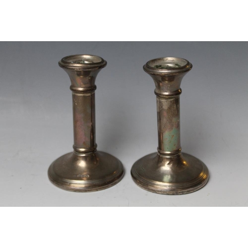 237 - A PAIR OF HALLMARKED SILVER CANDLESTICKS - BIRMINGHAM 1922, one with damage to base, bases filled, H... 