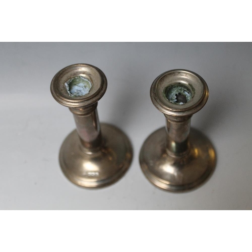 237 - A PAIR OF HALLMARKED SILVER CANDLESTICKS - BIRMINGHAM 1922, one with damage to base, bases filled, H... 