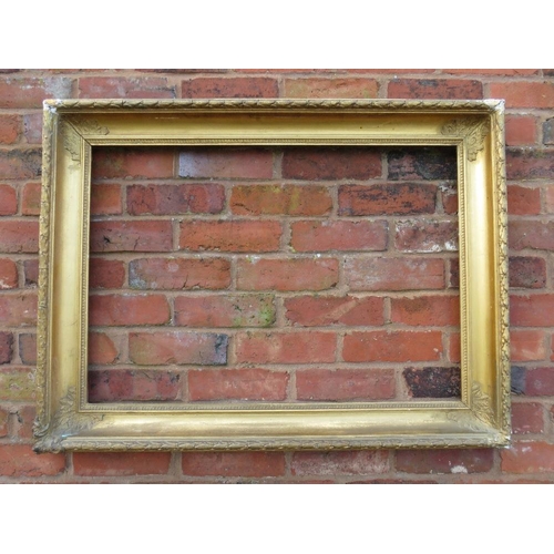 24 - A GILT RECTANGULAR PICTURE FRAME, with acanthus moulded detail to each corner, rebate 83 x 58 cm