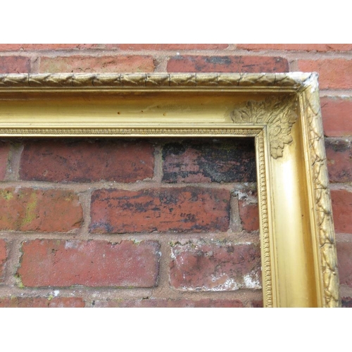 24 - A GILT RECTANGULAR PICTURE FRAME, with acanthus moulded detail to each corner, rebate 83 x 58 cm