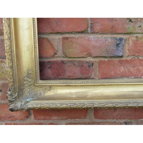 24 - A GILT RECTANGULAR PICTURE FRAME, with acanthus moulded detail to each corner, rebate 83 x 58 cm