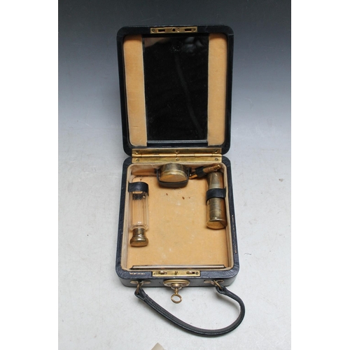 241 - A SMALL TRAVELLING VANITY CASE WITH HALLMARKED SILVER GILT ACCESSORIES,  complete with a base metal ... 