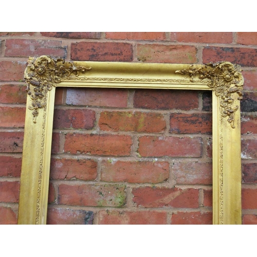 25 - A GILT RECTANGULAR PICTURE FRAME, with foliate moulded detail to each corner, rebate 68 x 55 cm