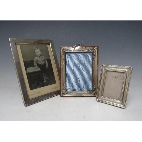 258 - THREE VINTAGE HALLMARKED SILVER PHOTOGRAPH FRAMES, with strut backs, site sizes -  17.5 x 12 cm, 13.... 