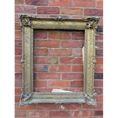 26 - A GILT RECTANGULAR PICTURE FRAME, with raised moulded foliate detail, rebate 65 x 52 cm