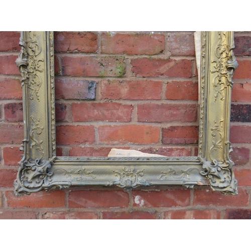 26 - A GILT RECTANGULAR PICTURE FRAME, with raised moulded foliate detail, rebate 65 x 52 cm