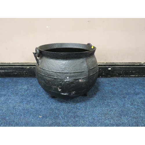 273 - A LARGE AND HEAVY CAST CAULDRON, with swing handle, on three feet, H 38 cm, W 49 cm A/FCondition Rep... 