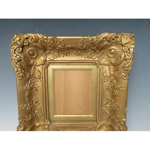 28 - A 19TH CENTURY SMALL DECORATIVE GOLD FRAME, with gold slip and glazed, frame W 7 cm, slip rebate 13.... 