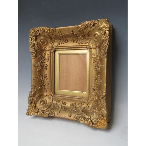 28 - A 19TH CENTURY SMALL DECORATIVE GOLD FRAME, with gold slip and glazed, frame W 7 cm, slip rebate 13.... 