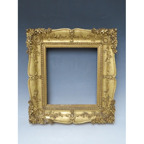 29 - A 19TH CENTURY DECORATIVE GOLD SWEPT FRAME, frame W 6.5 cm, rebate 23 x 20 cm