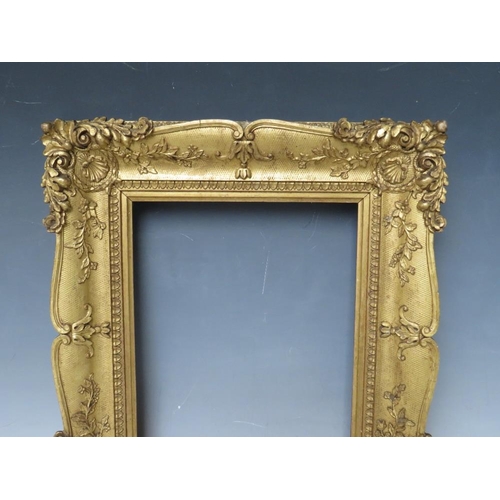 29 - A 19TH CENTURY DECORATIVE GOLD SWEPT FRAME, frame W 6.5 cm, rebate 23 x 20 cm