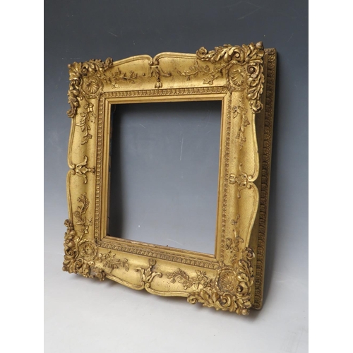 29 - A 19TH CENTURY DECORATIVE GOLD SWEPT FRAME, frame W 6.5 cm, rebate 23 x 20 cm