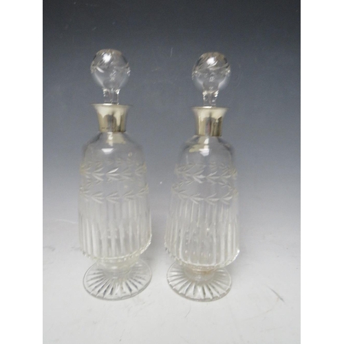 331 - A PAIR OF SILVER COLLARED GLASS DECANTERS - BIRMINGHAM 1929, H 25 cm