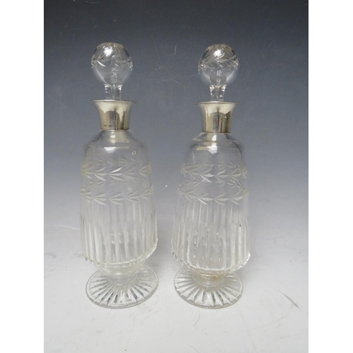 331 - A PAIR OF SILVER COLLARED GLASS DECANTERS - BIRMINGHAM 1929, H 25 cm