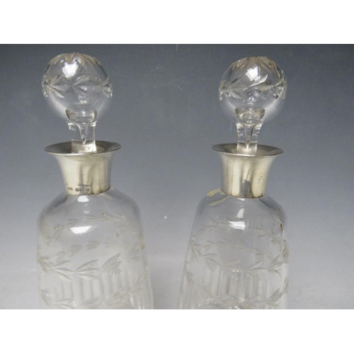 331 - A PAIR OF SILVER COLLARED GLASS DECANTERS - BIRMINGHAM 1929, H 25 cm