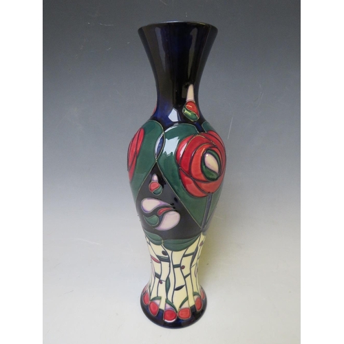 348 - A MOORCROFT POTTERY BALUSTER VASE, with tubelined floral design on a dark blue ground, marks and sig... 