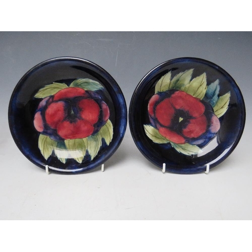 351 - A PAIR OF MOORCROFT PANSY PATTERN DISHES, with tubelined decoration, impressed marks and signed with... 