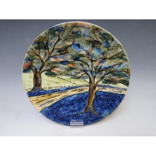 360 - A COBRIDGE CIRCULAR CHARGER BY ANITA HARRIS, decorated with trees, impressed factory mark, limited e... 