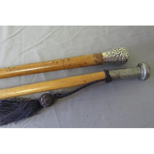 384 - TWO 19TH CENTURY MALACCA WALKING STICKS, with white metal knops, average  88 cm