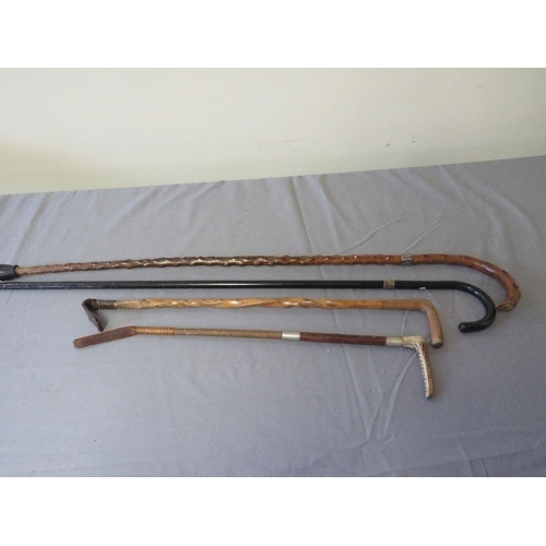 385 - TWO VINTAGE SILVER MOUNTED WALKING STICKS, average L 85 cm, together with two vintage riding crops, ... 