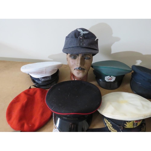 428 - A COLLECTION OF VARIOUS MILITARY CAPS AND BERETS ETC., to include Naval and German types, along with... 