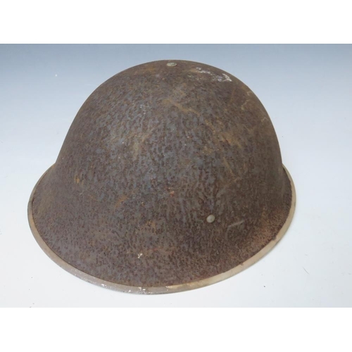 429 - A BRITISH TIN HELMET DATED 1941, with stencilled S.F.P. to the front together with an Eastern Europe... 