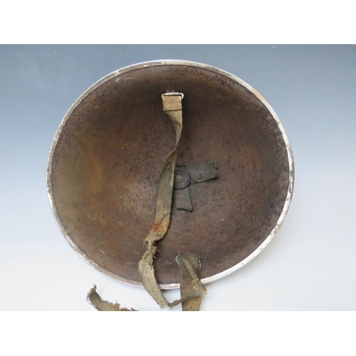 429 - A BRITISH TIN HELMET DATED 1941, with stencilled S.F.P. to the front together with an Eastern Europe... 