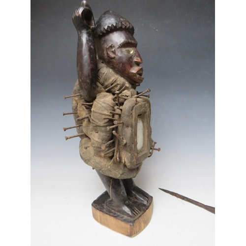 434 - A KONGO POWER FIGURE BRANDISHING AN IRON SPEAR WITH INSET GLASS EYES AND A PANEL TO HIS ABDOMEN, H 4... 