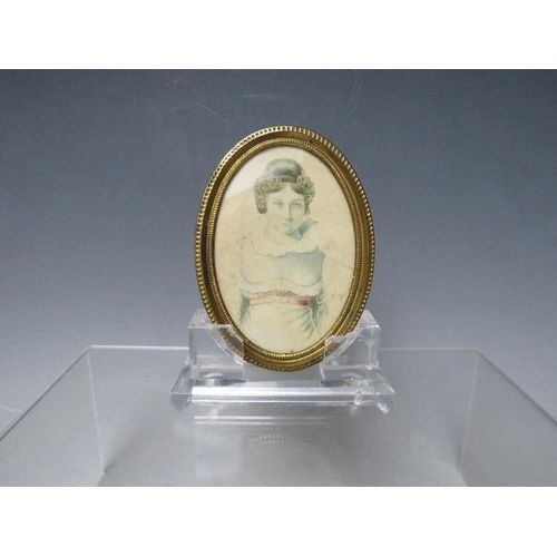 44 - A 19TH CENTURY OVAL PORTRAIT MINIATURE OF A YOUNG WOMAN, unsigned, watercolour on paper, framed and ... 