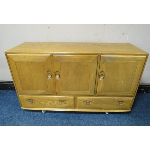 493 - AN ERCOL LIGHT ELM SIDEBOARD, with two drawers, on castors, W 130 cm