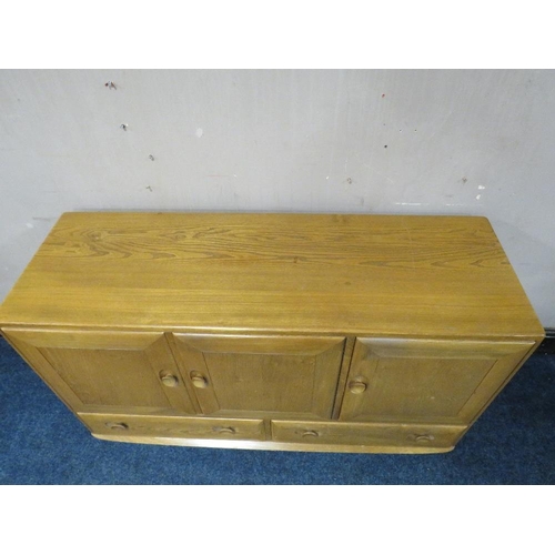 493 - AN ERCOL LIGHT ELM SIDEBOARD, with two drawers, on castors, W 130 cm