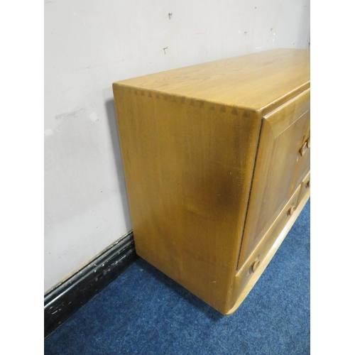 493 - AN ERCOL LIGHT ELM SIDEBOARD, with two drawers, on castors, W 130 cm