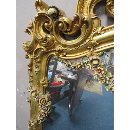 497 - A LARGE MODERN GILT COMPOSITE OVERMANTLE MIRROR, with Rococo and floral scrolling, 172 x 170 cm