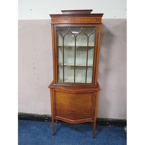 499 - AN EDWARDIAN MAHOGANY INLAID DISPLAY CABINET, the serpentine fronted lower section with single door,... 