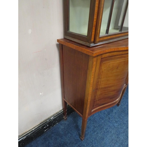 499 - AN EDWARDIAN MAHOGANY INLAID DISPLAY CABINET, the serpentine fronted lower section with single door,... 