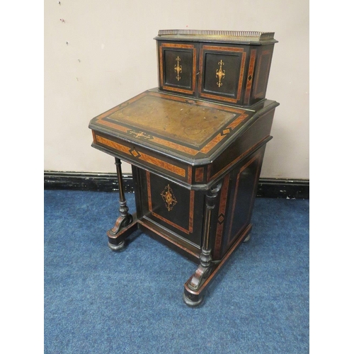 503 - A 19TH CENTURY EBONISED AND WALNUT DAVENPORT, the twin door upper section opening to drawers and pig... 