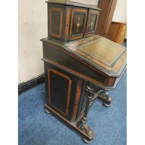 503 - A 19TH CENTURY EBONISED AND WALNUT DAVENPORT, the twin door upper section opening to drawers and pig... 